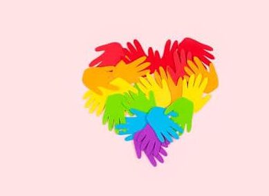 Many rainbow color palm hands on pink background with copy space.