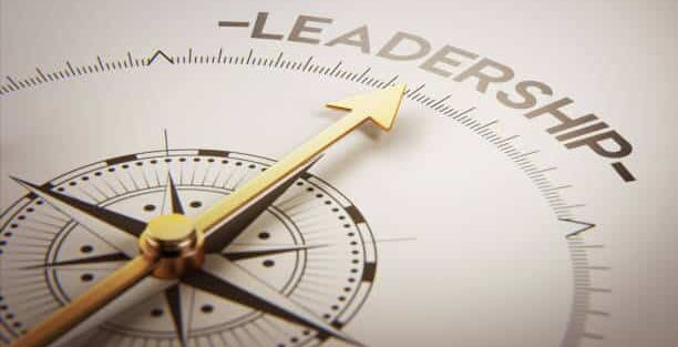 A compass points to the word leadership