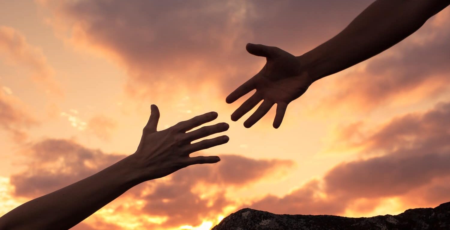 two hands reaching for eachother