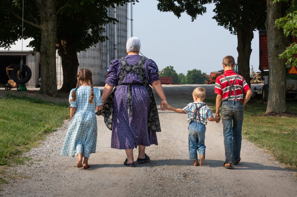 Mother with children walking holding hands